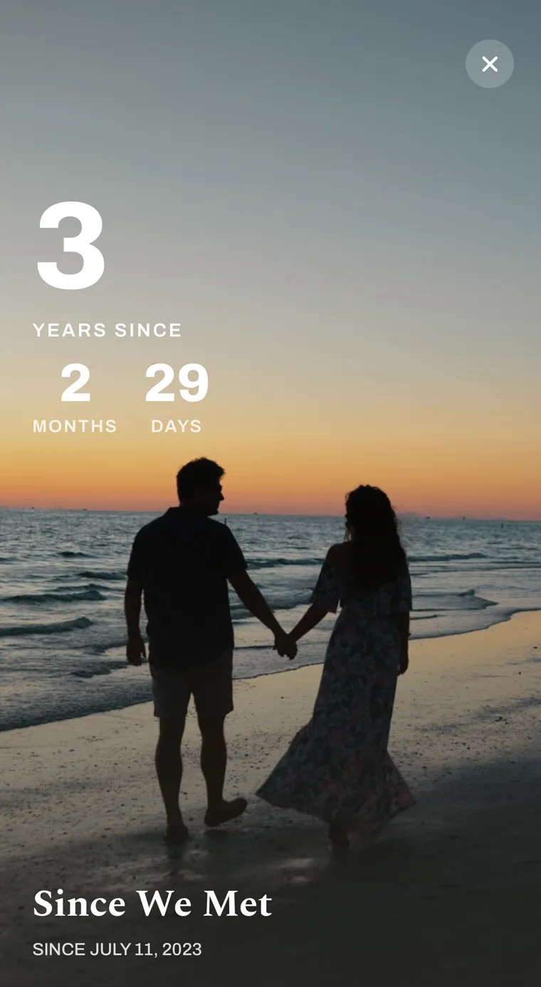 Count-up in Countdown Day: 3 years, 2 months, 29 days since we met, over a photo of a couple on a beach